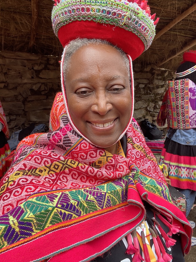 Cassandra Washington in Peru, wearing a traditional red headdress